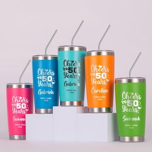 May include: Five colorful stainless steel tumblers with silver straws. Each tumbler is a different color: pink, blue, teal, orange, and green. The text "Cheers to 50 Years" is printed on each tumbler, along with a name and "Punta Cana 2026".