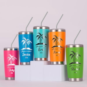 May include: A collection of five insulated tumblers in vibrant colors: pink, blue, teal, orange, and green. Each tumbler features a silver palm tree design and a name with the word "Jamaica" and the year "2026". Stainless steel straws are included.