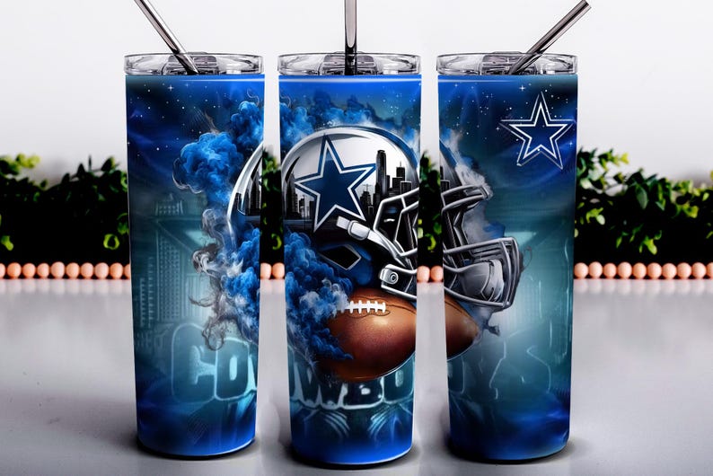 May include: A set of three stainless steel tumblers with lids and straws. Each tumbler features a blue and white design with a football helmet, a football, and the Dallas Cowboys star logo. The word "COWBOYS" is visible on one of the tumblers.