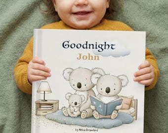 May include: A smiling baby in a mustard yellow sweater holds a children's book titled "Goodnight John." The book cover features illustrations of koala bears reading a book. The background is a soft green.