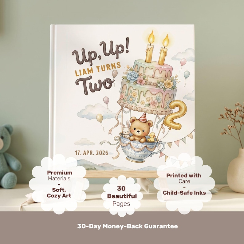 Puede incluir: Una portada de libro de tapa dura con una ilustraci&oacute;n caprichosa de un oso de peluche en un globo aerost&aacute;tico de taza de t&eacute; con un pastel, globos y el texto Up, Up! LIAM TURNS Two y 17. APR. 2026. El dise&ntilde;o incluye colores pastel suaves.