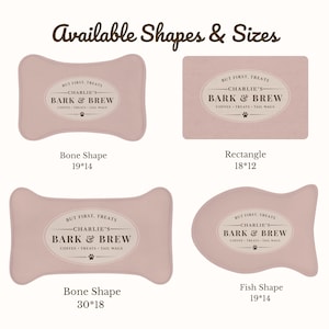 May include: Four dusty pink pet mats in bone, rectangular, and fish shapes. Each mat features an oval label with the text 'BUT FIRST, TREATS', 'CHARLIE'S BARK & BREW', and 'COFFEE &bull; TREATS &bull; TAIL WAGS' with a paw print icon. Sizes include 19x14, 18x12, and 30x18.