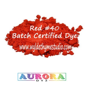May include: Red #40 Batch Certified Dye, a bright red powder in a pile. The text "www.wyldethyme studio.com" is printed below the pile of dye. The text "AURORA DYZ" is printed below the pile of dye.