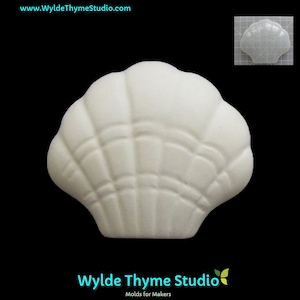 May include: White ceramic seashell mold for crafting. The mold is detailed with a ribbed texture and has a smooth, rounded shape.