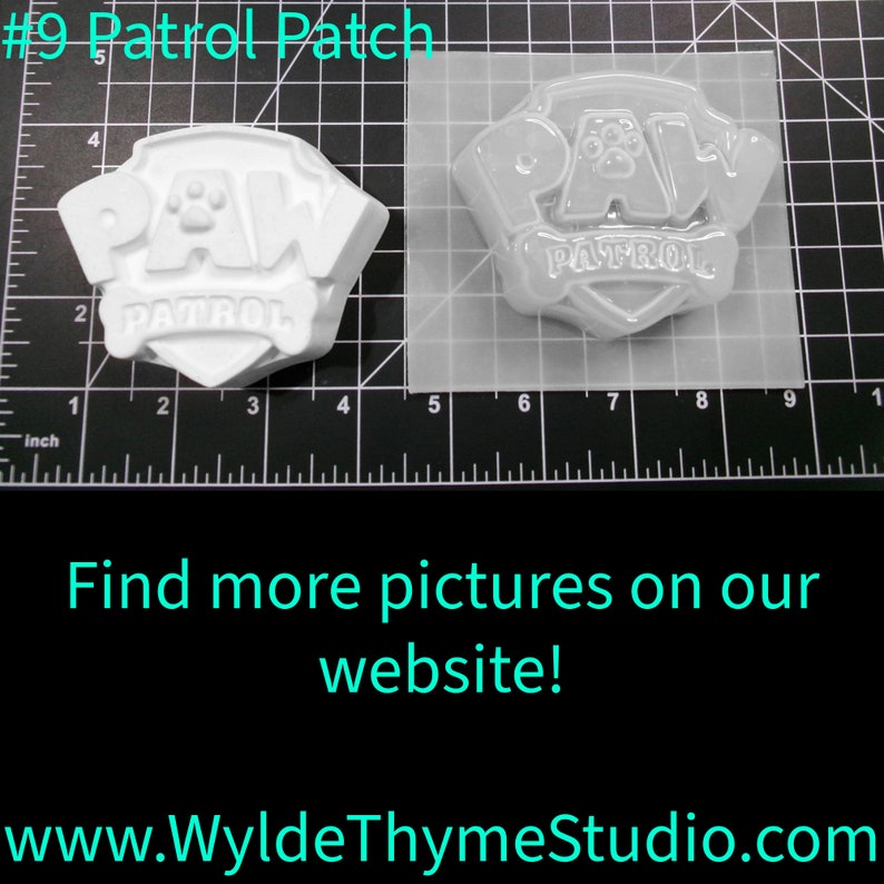 May include: A white plastic mold for making a Paw Patrol logo. The mold is 4 inches wide and 3 inches tall. The mold is on a gridded surface. The text #9 Patrol Patch is visible in the image.