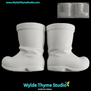 May include: Two white ceramic Santa boot molds. The molds are designed to create edible chocolate or candy Santa boots.