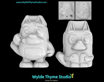 May include: Two white plastic molds of a cartoon dog character. The dog is standing on its hind legs with its front paws raised. The molds are for making soap, candles, or other crafts.