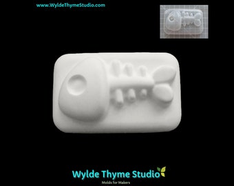 May include: White plastic mold of a fish skeleton with a large head and a small tail. The mold is rectangular and has a smooth surface.