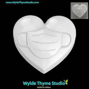 May include: White heart-shaped mold with a raised design of a face mask. The mold is made of silicone and is perfect for making soap, candles, or other crafts.