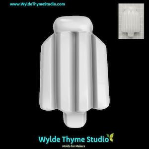 May include: A white, glossy, vertical mold with a rounded top and a flared, ribbed body. The mold has a small, rectangular base. The image also includes a smaller, inset image of the mold. The text "Wylde Thyme Studio" is at the bottom.