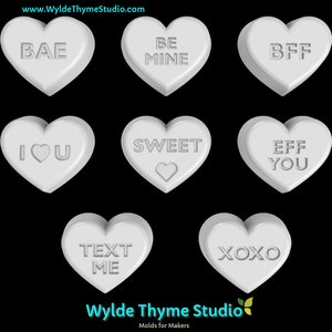 May include: Nine white heart-shaped candy molds with different sayings: BAE, BE MINE, BFF, I LOVE YOU, SWEET, EFF YOU, TEXT ME, XOXO.  Wylde Thyme Studio molds for makers.