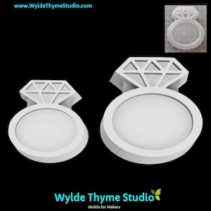 May include: Two white diamond ring molds, one large and one small, with a diamond-shaped top and a circular base. The image includes the text "www.WyldeThymeStudio.com" and "Wylde Thyme Studio Molds for Makers".