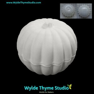 May include: White ceramic pumpkin mold for crafting. The mold is smooth and has a rounded shape with a slightly indented top.