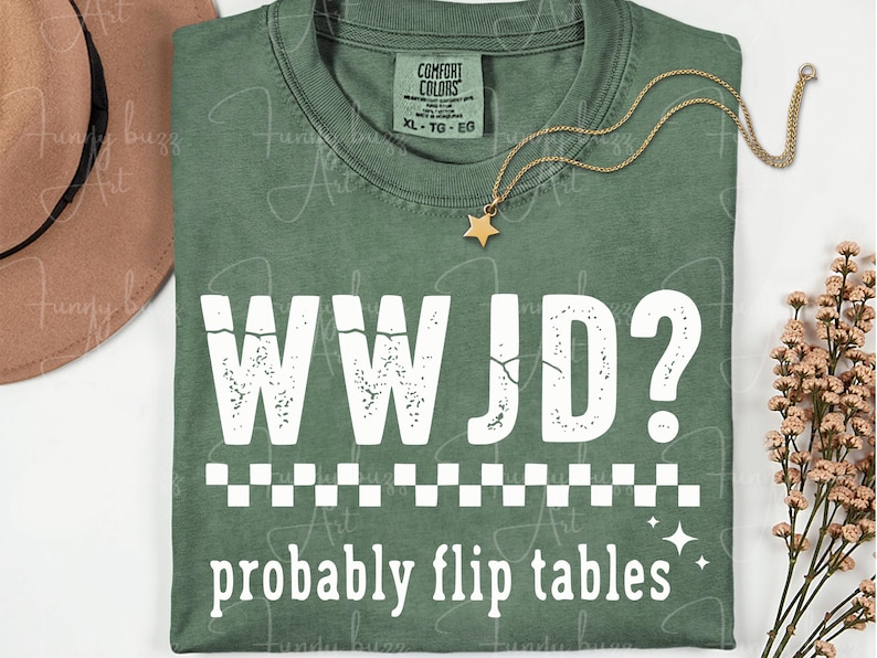 May include: Green t-shirt with the text "WWJD? probably flip tables" in white. The shirt has a crew neck and short sleeves. A gold star pendant necklace and a brown hat are also visible.