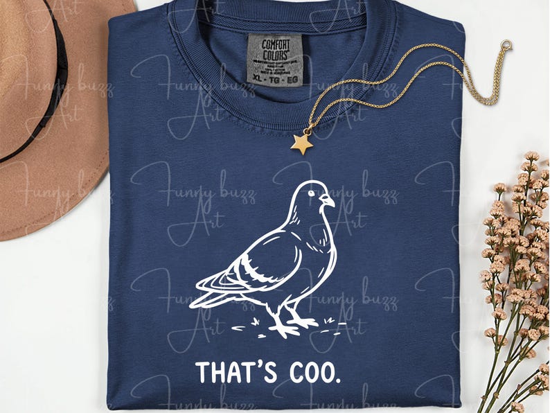 May include: Navy blue t-shirt with a white outline drawing of a pigeon and the text "THAT'S COO." A gold star pendant hangs on a gold chain. The shirt is labeled XL-TG-EG.