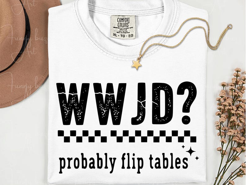 May include: White t-shirt with the text "WWJD? probably flip tables" in black. The shirt has a crew neck and a tag that says "Comfort Colors". A gold star pendant necklace is draped on the shirt.