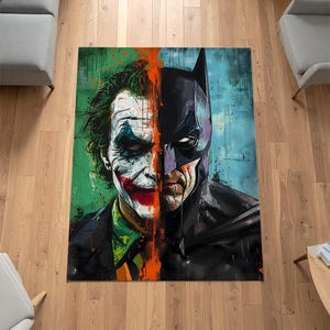 May include: A rectangular rug featuring a split design of the Joker and Batman. The Joker's side has green and red accents, while Batman's side is predominantly black and purple. The artwork has a painted, textured appearance.