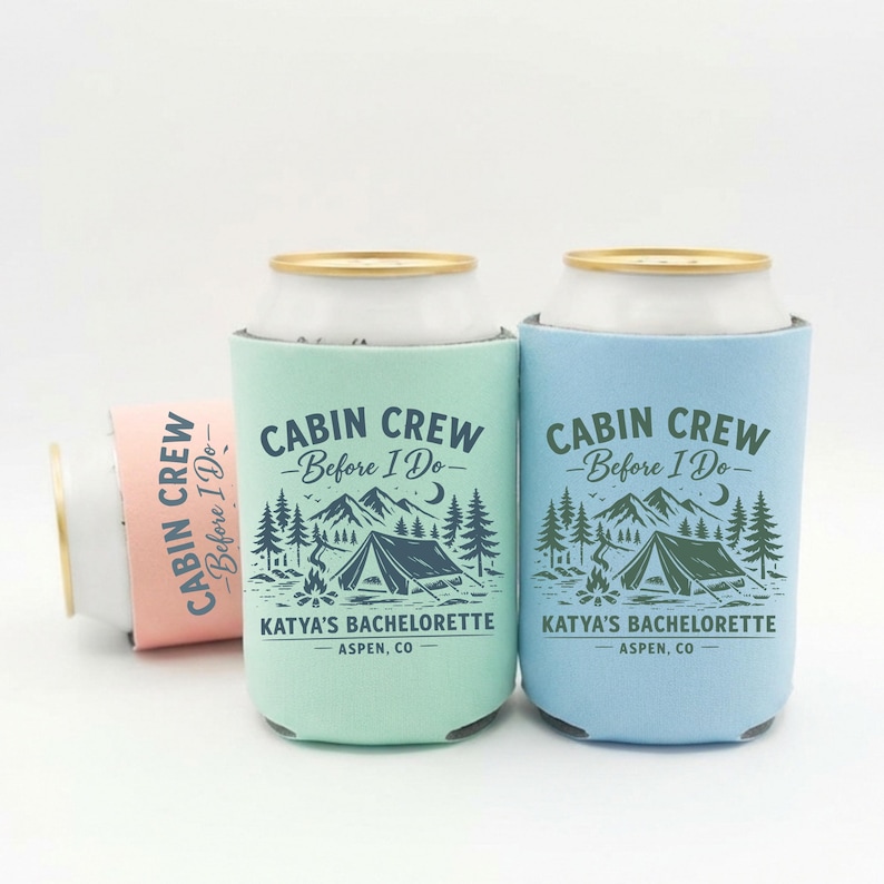 May include: Three can coolers in shades of blue, green, and pink. Each cooler has the text "CABIN CREW - Before I Do-" and "KATYA'S BACHELORETTE - ASPEN, CO" with a camping scene design.
