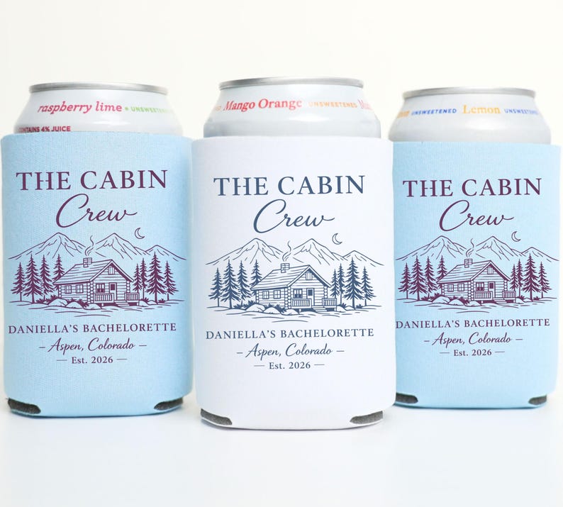 May include: Three drinks can coolers with the text "THE CABIN Crew" and a cabin graphic. The coolers are light blue and white, with the text "DANIELLA'S BACHELORETTE - Aspen, Colorado - Est. 2026".