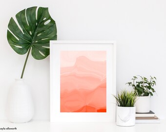 May include: A framed print of a pink and orange abstract watercolor painting with a white frame. The print is on a white shelf with a green plant in a white vase and two green plants in white pots.