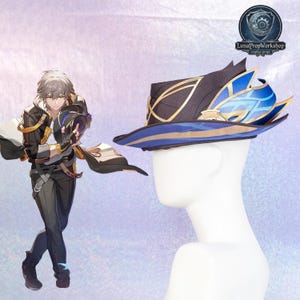 May include: A black and blue hat with gold accents, displayed on a white mannequin head. The hat features a wide brim and decorative elements, including a stylized blue feather design. The hat is likely a cosplay or costume accessory.