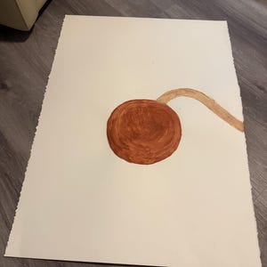 May include: A painting on a white paper. The painting features a large, round, brown shape with a stem-like extension. The artwork is abstract and appears to be created with paint.