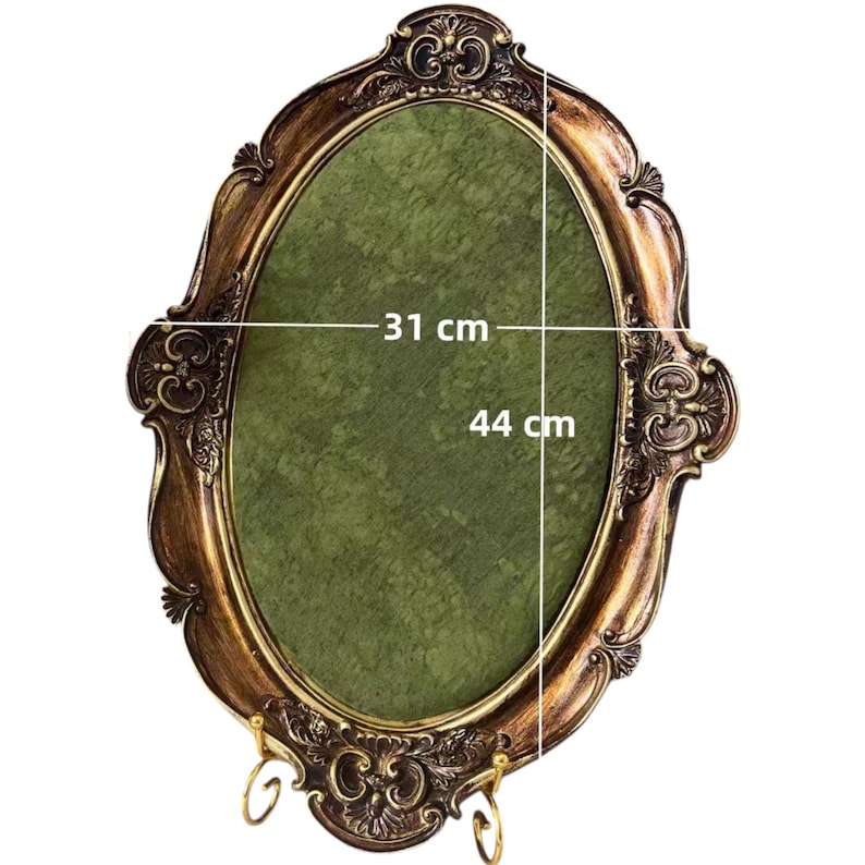 May include: Ornate oval picture frame with a gold and bronze finish. The frame has decorative scrollwork and a green interior. The frame measures 12.2 inches wide by 17.3 inches high.