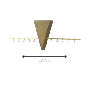May include: Wooden jewelry organiser with a triangular wooden base and a horizontal gold-coloured bar with hooks. The organiser is approximately 25 cm wide, as indicated by the text in the image.