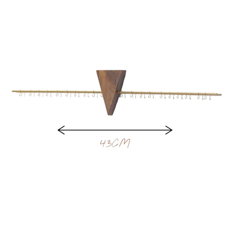 May include: A wooden jewellery organiser with a triangular centre piece and a horizontal bar with small hooks. The organiser is 43cm (16.9 inches) wide. The wood has a natural grain, and the hooks are gold-coloured.