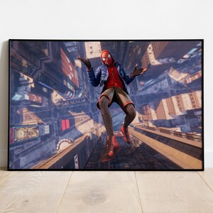 May include: Framed print featuring a character in a red and black suit with a blue jacket, set against a cityscape backdrop. The character is mid-air with arms outstretched, showcasing a dynamic pose. The artwork is displayed in a black frame.