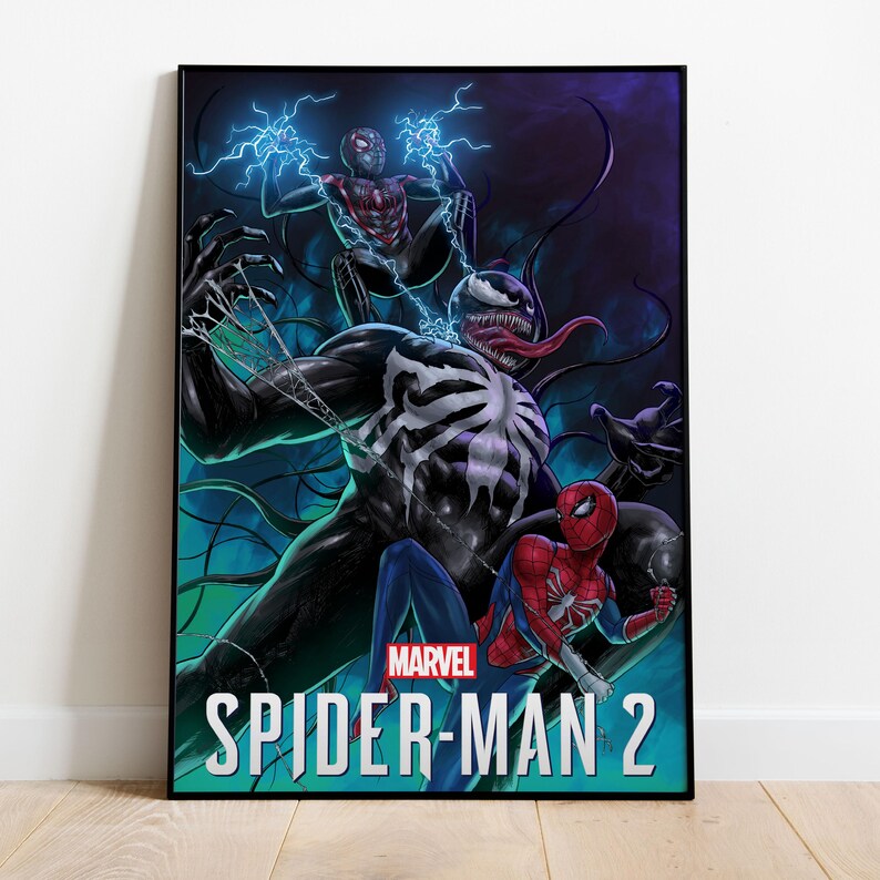 May include: A framed poster featuring Marvel's Spider-Man 2. The artwork depicts Spider-Man, Venom, and Miles Morales in action, with vibrant colors and dynamic poses. The Marvel logo is visible.