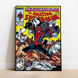 May include: A framed comic book cover featuring Spider-Man in a dynamic pose. The cover art has a yellow background with the title "The Amazing Spider-Man" and the Marvel logo. The artwork depicts a battle scene with multiple characters.