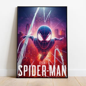 May include: A framed poster featuring Spider-Man in a dynamic pose against a cityscape backdrop. The superhero is depicted in a black and blue suit, with white web lines extending outwards. The Marvel logo is visible, along with the words "SPIDER-MAN".