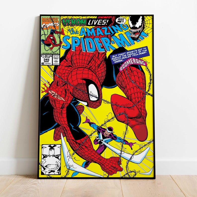 May include: Comic book cover art featuring Spider-Man in a dynamic pose, with the text "VENOM LIVES!" and "THE AMAZING SPIDER-MAN." The artwork has a yellow background with action lines and a villain. The comic is framed in black.