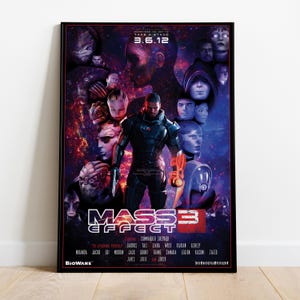 May include: A framed poster for "Mass Effect 3" featuring Commander Shepard. The artwork showcases a central figure in futuristic armor, surrounded by alien characters against a cosmic backdrop. The poster includes the date 3.6.12 and the Bioware logo.