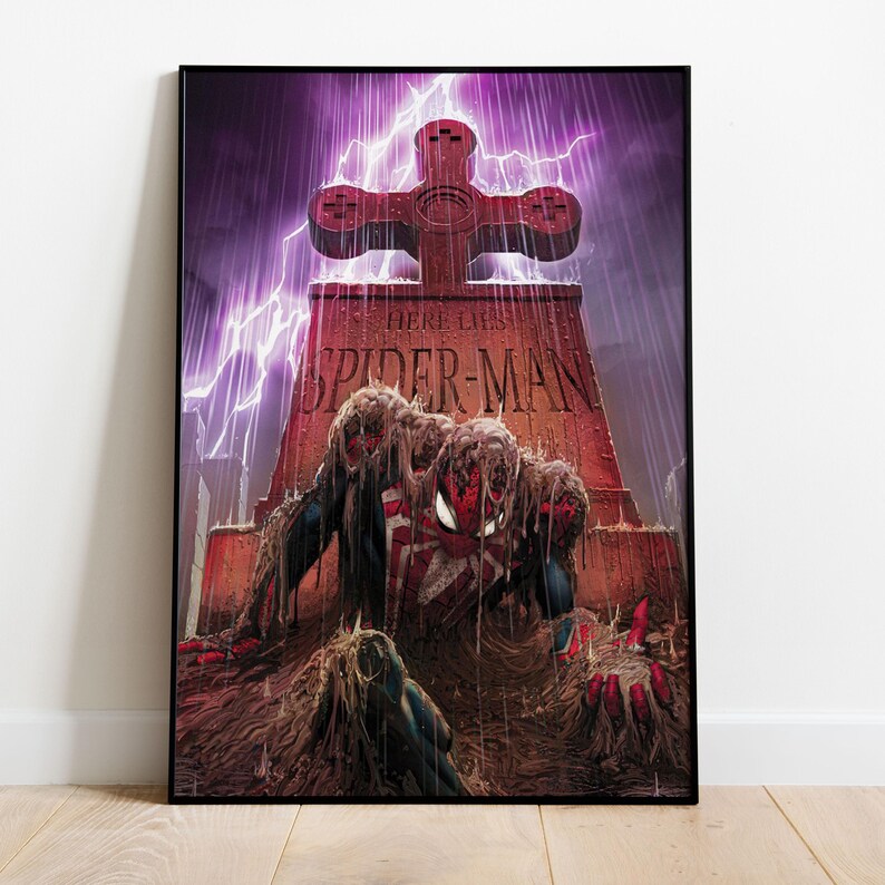 May include: A framed comic book art print featuring Spider-Man rising from a grave. The tombstone reads "Here Lies Spider-Man" with a cross-shaped top. The artwork is set against a purple stormy sky with lightning.