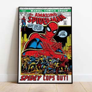 May include: A framed comic book cover featuring Spider-Man. The cover art shows Spider-Man in a red and blue suit with his hands outstretched. The title "Amazing Spider-Man" is prominently displayed, along with the text "Spidey Cops Out!"