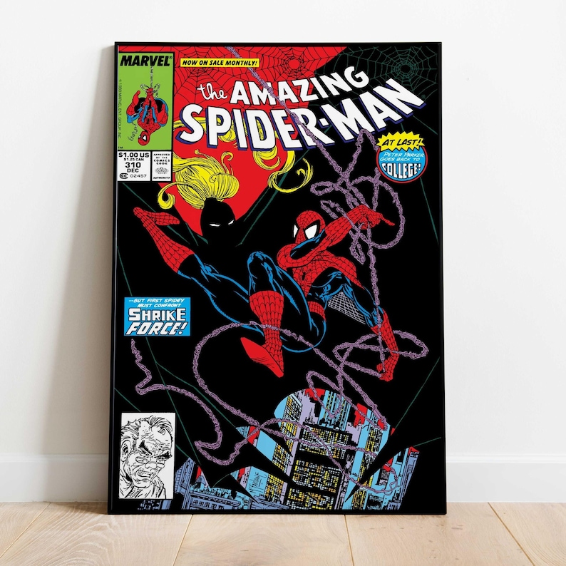 May include: A framed comic book cover of The Amazing Spider-Man. The cover features Spider-Man in a red and blue suit swinging from a web against a black background. The text includes "MARVEL" and "SHRIKE FORCE!"