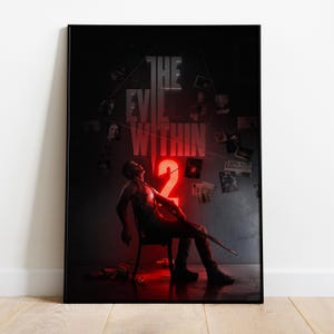 May include: A framed poster for "The Evil Within 2" video game. The image features a man sitting in a chair, with the game's title and a large "2" in red neon. The background is dark with scattered images.