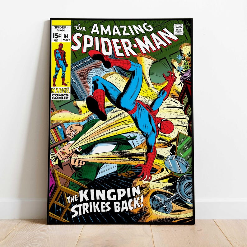 May include: A framed comic book cover featuring Spider-Man in a dynamic pose. The title reads "The Amazing Spider-Man" with the text "The Kingpin Strikes Back!" visible. The artwork is in vibrant colors, with a vintage comic book style.