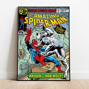 May include: A framed comic book cover of "The Amazing Spider-Man" featuring Spider-Man battling the Man-Wolf. The cover has vibrant colors, with text that reads "Mayhem is the Man-Wolf!" and "Marvel Comics Group".