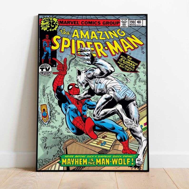 May include: A framed comic book cover of "The Amazing Spider-Man" featuring Spider-Man battling the Man-Wolf. The cover has vibrant colors, with text that reads "Mayhem is the Man-Wolf!" and "Marvel Comics Group".