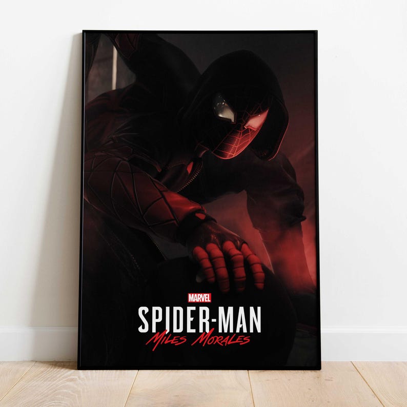 May include: A framed poster featuring Spider-Man, Miles Morales, in a dynamic pose. The artwork is predominantly black and red, with the Marvel logo and the title "Spider-Man: Miles Morales" in white text.