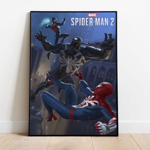 May include: A framed poster featuring Marvel's Spider-Man 2. The artwork depicts Spider-Man in a red and blue suit, battling Venom and Miles Morales in a rainy cityscape. The Marvel logo and title are at the top.