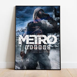 May include: Framed poster featuring the video game "Metro Exodus." The artwork depicts a figure in a gas mask and hooded jacket, set against a snowy, mountainous backdrop. The game's title is prominently displayed in white block letters.
