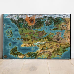 May include: A framed fantasy map with a detailed, colorful illustration of a fictional world. The map features landmasses, oceans, mountains, forests, and various geographical features. The map is framed in black and is displayed on a light-colored wooden surface.