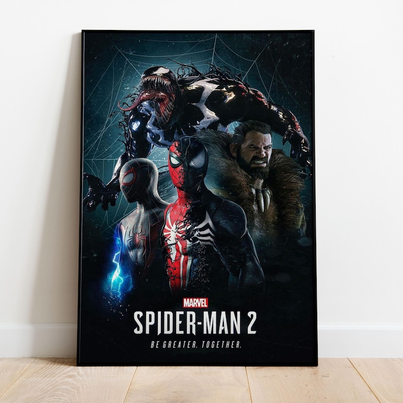 May include: A framed poster featuring characters from Marvel's Spider-Man 2. The artwork includes Venom, Spider-Man, Miles Morales, and Kraven the Hunter. The poster has the Marvel logo and the text "SPIDER-MAN 2 BE GREATER. TOGETHER."