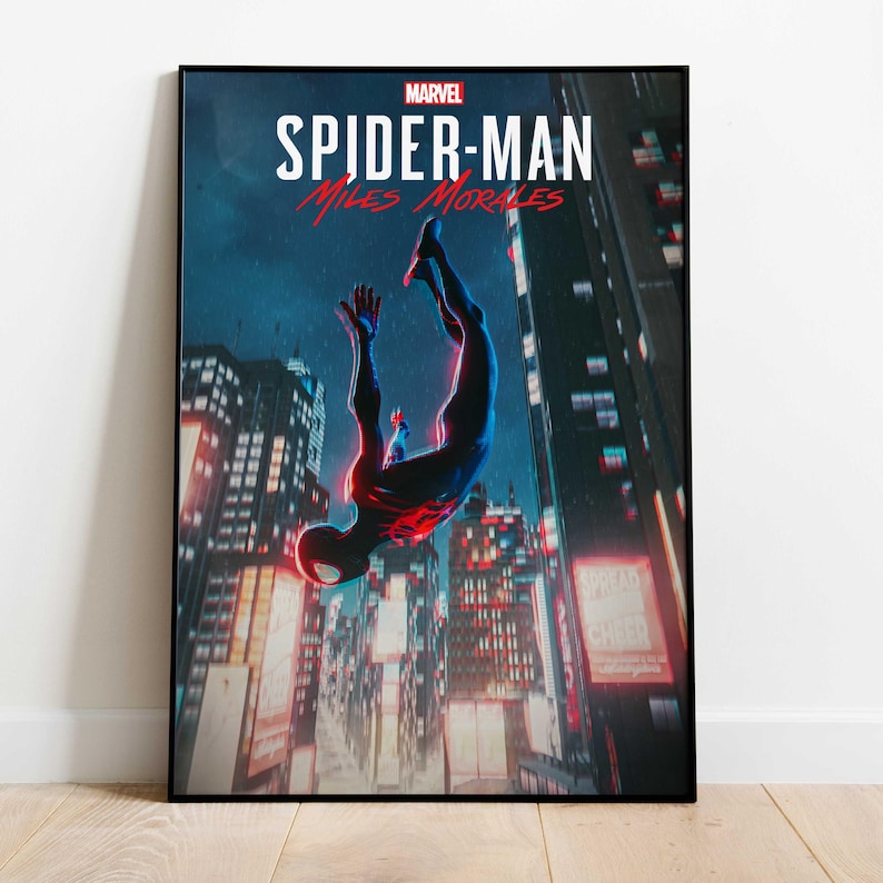 May include: A framed poster featuring the Marvel Spider-Man: Miles Morales video game. The artwork depicts Spider-Man in a dynamic pose, falling through a cityscape at night. The poster has a black frame.