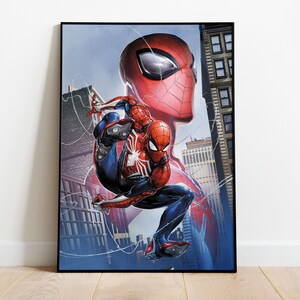 May include: Framed artwork featuring Spider-Man in a dynamic pose against a cityscape backdrop. The illustration showcases Spider-Man in his iconic red and blue suit, with a large Spider-Man head in the background. The artwork is set in a black frame.
