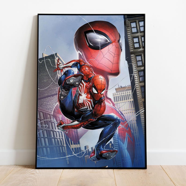 May include: Framed artwork featuring Spider-Man in a dynamic pose against a cityscape backdrop. The illustration showcases Spider-Man in his iconic red and blue suit, with a large Spider-Man head in the background. The artwork is set in a black frame.